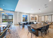 Thumbnail 7 of 41 - A large conference room with a long table and chairs.
