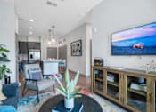 Thumbnail 19 of 41 - A modern living room with a flat screen TV mounted on the wall.