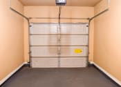 Thumbnail 58 of 69 - a garage with white doors and a black floor