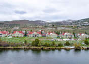 Thumbnail 2 of 20 - a group of houses sitting next to a body of water