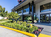 Thumbnail 25 of 27 - A building with a yellow and black striped walkway in front of it.
