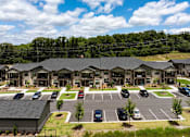 Thumbnail 47 of 50 - an aerial view of an apartment complex with cars parked in a parking lot