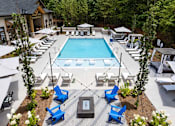 Thumbnail 35 of 50 - a resort style pool with blue chairs and chairs around it