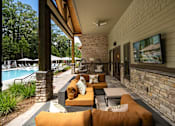 Thumbnail 30 of 50 - a covered patio with couches and a tv