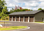 Thumbnail 42 of 50 - Acworth, GA Apartments - The Brookstone - Parking Lot with Garage and Trees.