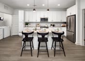 Thumbnail 12 of 50 - a kitchen with a center island with three bar stools