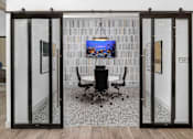Thumbnail 5 of 50 - a conference room with a table and a tv on the wall