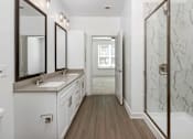 Thumbnail 23 of 50 - a bathroom with a shower and a sink and a mirror
