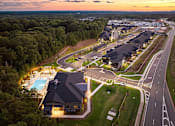 Thumbnail 43 of 50 - an aerial view of a resort with a swimming pool at dusk