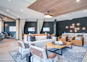Thumbnail 19 of 26 - A modern living room with a wooden ceiling and a black accent wall.