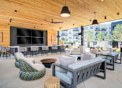 Thumbnail 10 of 26 - A modern outdoor seating area with wooden ceiling and furniture.