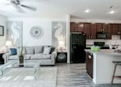 Thumbnail 3 of 29 - a living room and kitchen with a couch and a table