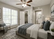 Thumbnail 5 of 22 - A bedroom with a bed, chair, and a ceiling fan.