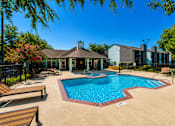 Thumbnail 11 of 22 - A pool surrounded by a black fence and a building in the background.