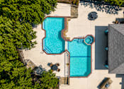 Thumbnail 21 of 22 - A swimming pool surrounded by trees and a building.