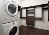 Thumbnail 29 of 44 - a washer and dryer sit next to each other in a laundry room