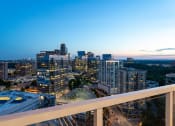 Thumbnail 43 of 44 - a city skyline at dusk from a high rise building