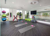Thumbnail 15 of 44 - a yoga studio with yoga mats on the floor and a tv on the wall