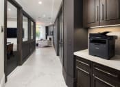 Thumbnail 9 of 44 - a kitchen with dark cabinets and white countertops