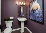 Thumbnail 24 of 44 - a bathroom with purple walls and a large painting on the wall