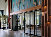 Thumbnail 9 of 31 - a large lobby with high ceilings and large glass windows