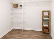 Thumbnail 10 of 15 - A white shelf with a basket and a plant on it.