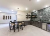 Thumbnail 9 of 28 - a kitchen with a bar and a table with chairs