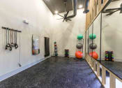 Thumbnail 16 of 28 - a workout room with weights on the wall and a treadmill