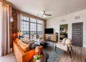 Thumbnail 19 of 28 - an open living room with a leather couch and a tv