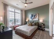 Thumbnail 23 of 28 - a bedroom with a bed and a ceiling fan