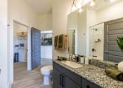 Thumbnail 24 of 28 - a bathroom with a sink and a toilet and a mirror
