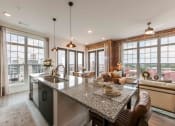 Thumbnail 1 of 28 - an open kitchen and living room with large windows
