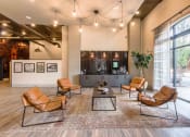 Thumbnail 10 of 28 - a lobby with leather chairs and a coffee table