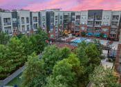 Thumbnail 45 of 45 - an aerial view of an apartment complex with a pool and trees