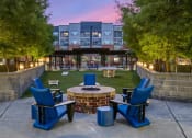 Thumbnail 38 of 45 - an outdoor patio with chairs and a fire pit