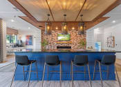 Thumbnail 5 of 45 - a kitchen with a blue counter top and a brick fireplace
