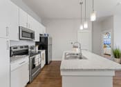 Thumbnail 24 of 45 - a kitchen with a counter top and a sink