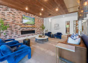 Thumbnail 6 of 45 - a living room with blue furniture and a brick fireplace