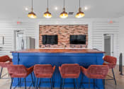 Thumbnail 16 of 45 - a kitchen with a blue counter and four chairs