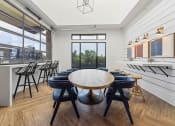 Thumbnail 18 of 45 - a dining room with a table and chairs