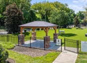 Thumbnail 42 of 45 - a park with a picnic area and a gazebo