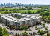 Thumbnail 43 of 45 - an aerial view of an apartment complex with a city in the background