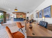 Thumbnail 8 of 45 - a living room with a wooden table and leather chairs