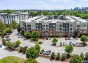 Thumbnail 44 of 45 - an aerial view of an apartment building in a parking lot