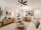 Thumbnail 4 of 50 - A living room with a white couch and a wooden coffee table.