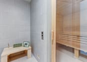Thumbnail 22 of 47 - A sauna room with a bench and a table.