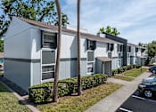 Thumbnail 21 of 25 - A row of modern townhouses with a clear blue sky above.