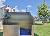 Thumbnail 40 of 49 - A playground with a slide and a blue mat.