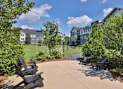 Thumbnail 36 of 49 - A sunny day at a park with chairs and trees.