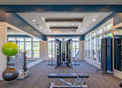 Thumbnail 11 of 49 - A spacious home gym with a variety of exercise equipment.